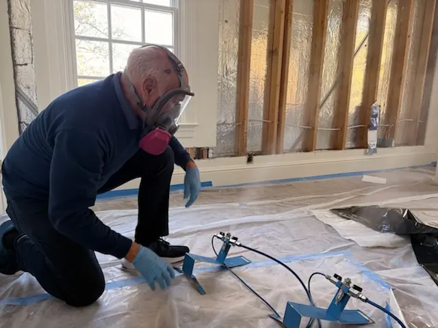 A restoration technician setting drying equipment in an Ventura home stripped to the studs