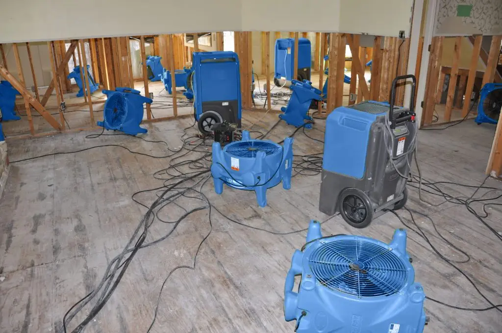 Air movers drying a gutted Ventura room after major water damage
